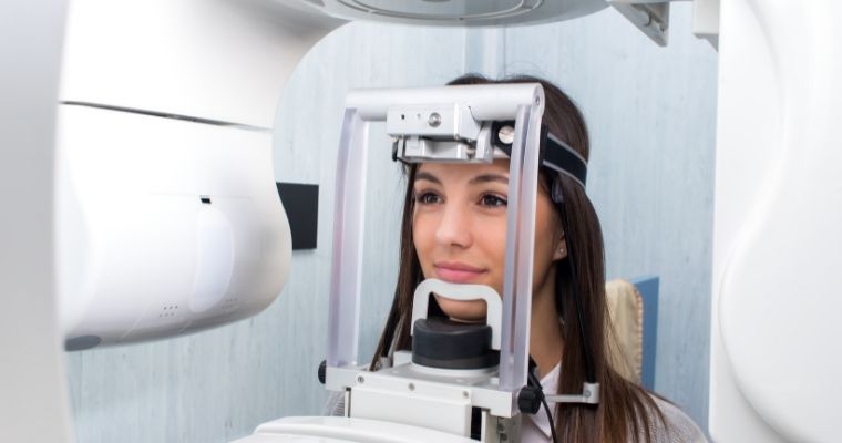 A woman getting a dental cone beam CT scan